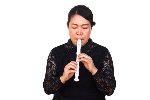 Asian woman flutist, musician is playing a recorder flute. Concept, music blowing with mouth, control with fingers on holes of flute for melody and rhythm. Mouthpiece musical instrument. photo