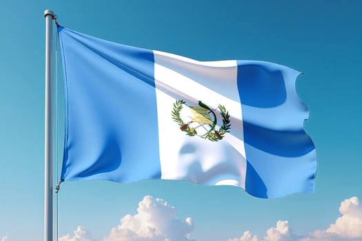 Guatemala Flag Waving Against Clear Blue Sky photo
