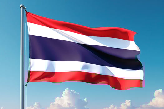 Thailand Flag Waving Against Clear Blue Sky photo