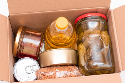 Food Reserves or Donation Box. Carton Box with Canned Food, Cereals and Grocery. Emergency Food Storage in Case of Crisis. Free Social Help, Blessings and Care. Strategic Food Supplies photo