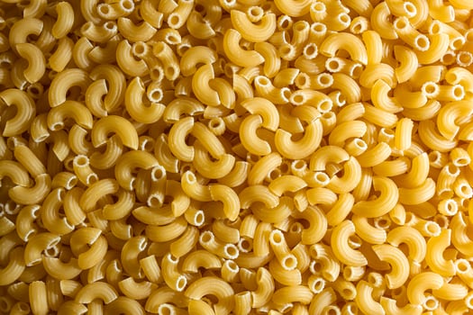 Uncooked Chifferi Rigati Pasta. A Culinary Canvas of Chifferi Rigati, Creating a Lively and Textured Background for Gourmet Cooking. Dry Pasta. Raw Macaroni - Top View, Flat Lay photo
