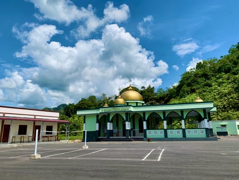 a gold domed mosque with a blue sky as a background photo