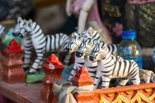 Small Zebra Statue Used as a Symbolic Offering in Thai Spiritual Shrine for Worship photo