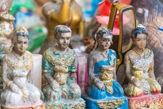 Traditional Thai Male and Female Figurines for Worship in Spirit Shrines photo