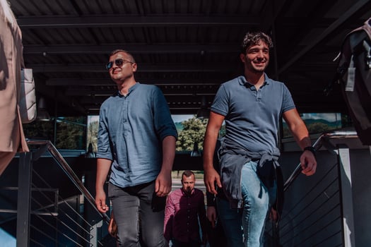 A diverse group of businessmen and colleagues walking together by their workplace, showcasing collaboration and teamwork in the company. photo