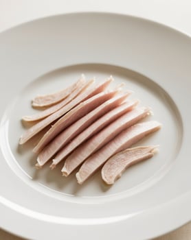 A white plate with sliced turkey on it photo
