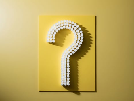Question mark on yellow background with shadow photo