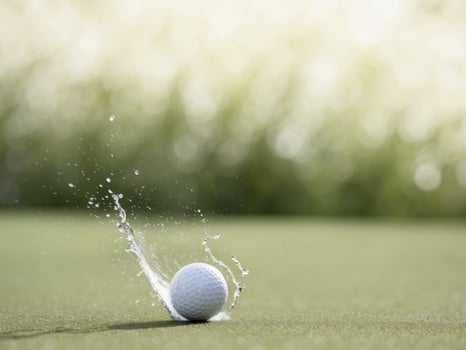 A golf ball is being hit by water photo