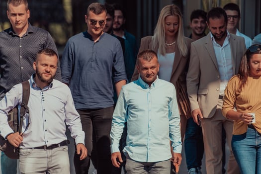 A diverse group of businessmen and colleagues walking together by their workplace, showcasing collaboration and teamwork in the company. photo