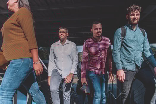 A diverse group of businessmen and colleagues walking together by their workplace, showcasing collaboration and teamwork in the company. photo