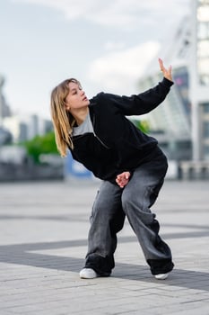 Dancer performing an expressive dance move in an urban setting photo