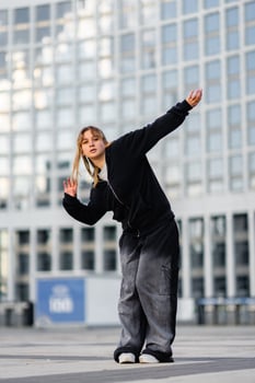 Young dancer performing expressive moves outdoors in an urban setting photo