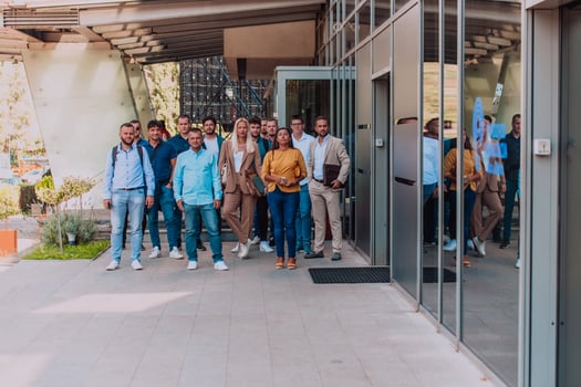 A diverse group of businessmen and colleagues walking together by their workplace, showcasing collaboration and teamwork in the company. photo