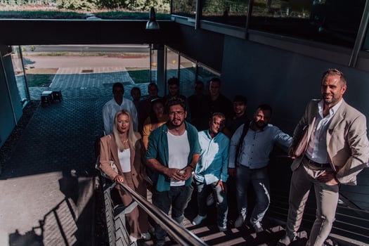 A diverse group of businessmen and colleagues walking together by their workplace, showcasing collaboration and teamwork in the company. photo