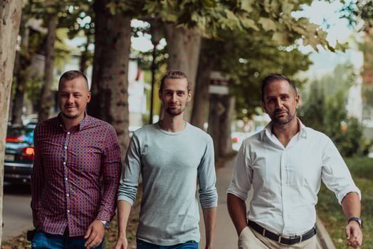After a productive day at work, a group of diverse colleagues enjoy a leisurely stroll through a modern and natural urban setting photo