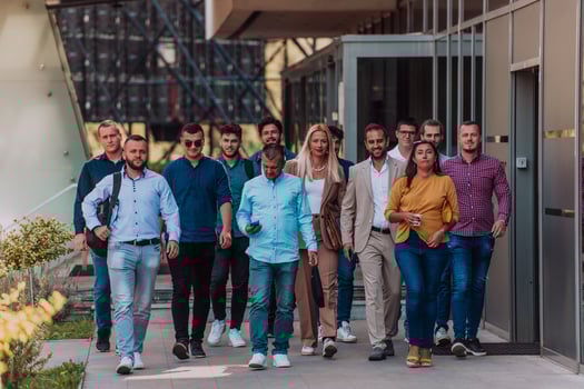 A diverse group of businessmen and colleagues walking together by their workplace, showcasing collaboration and teamwork in the company. photo