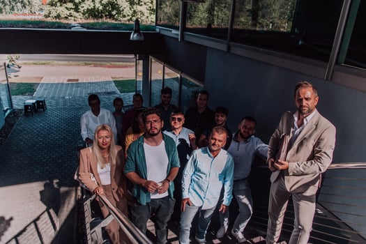 A diverse group of businessmen and colleagues walking together by their workplace, showcasing collaboration and teamwork in the company. photo