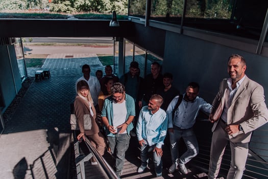A diverse group of businessmen and colleagues walking together by their workplace, showcasing collaboration and teamwork in the company. photo