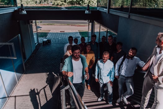 A diverse group of businessmen and colleagues walking together by their workplace, showcasing collaboration and teamwork in the company. photo