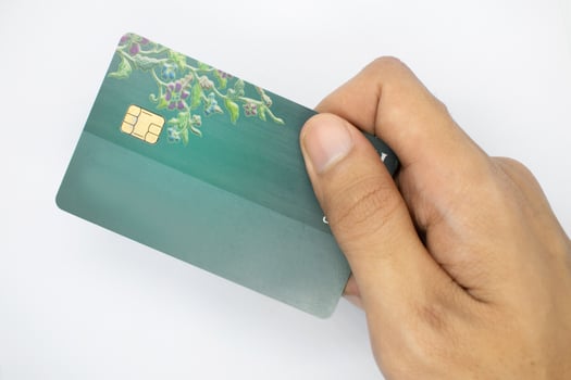 hand holding bank card on isolated white background. photo