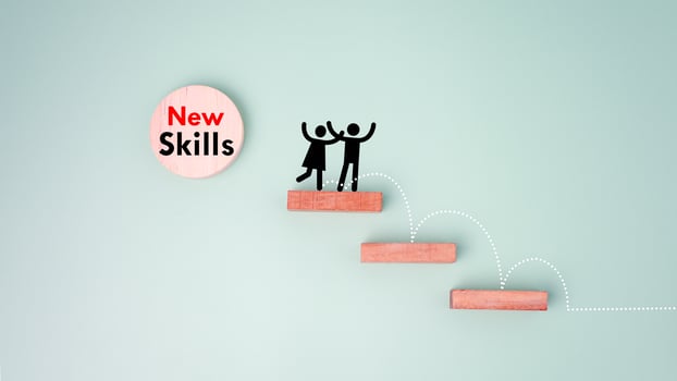 Skills icon and human drawing on wooden block. Upskilling and personal development concept. Employee thinking, digital upskill, Skill training, education, learning, ability. Upskilling, reskilling. photo