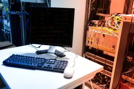 A computer monitor and keyboard on a desk photo