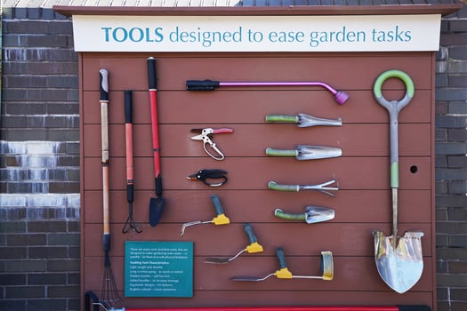 Garden tools and equipment hanging on wooden shed photo