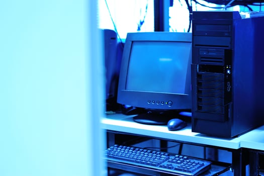 A computer desk with a computer, keyboard, mouse, and monitor photo