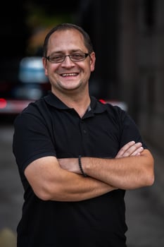 A successful businessman with crossed arms, posing outdoors photo