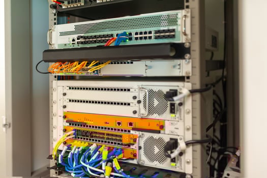 A rack of servers with various cables and wires photo