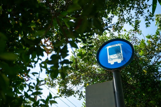A blue and white sign on a pole photo
