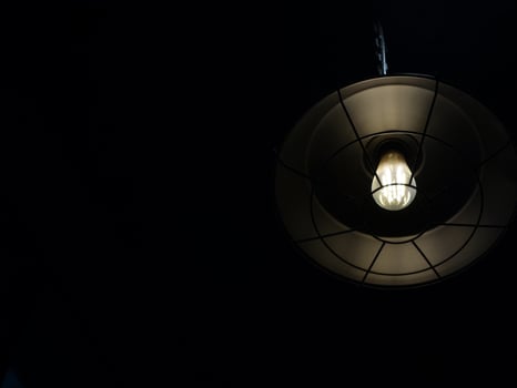 A light bulb hanging from a ceiling photo