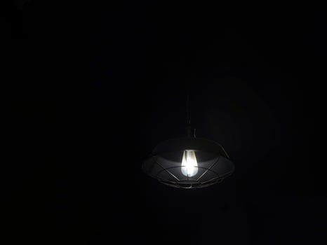 A light bulb is lit up in the dark photo