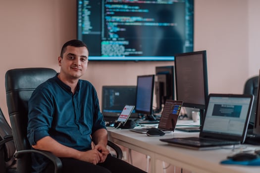 A programmer diligently testing smartphone applications while sitting in their office. photo