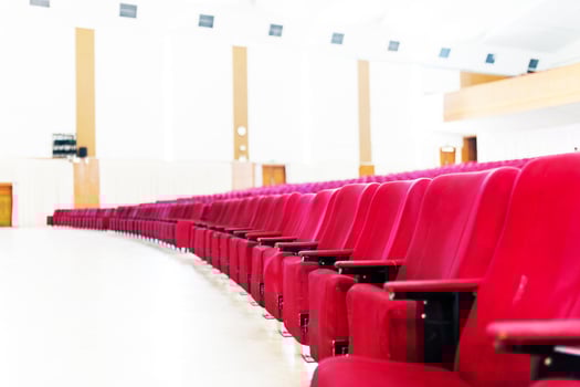 Empty seat on row in thearter closeup photo