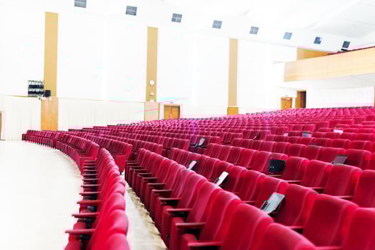 Empty seat on row in thearter closeup photo