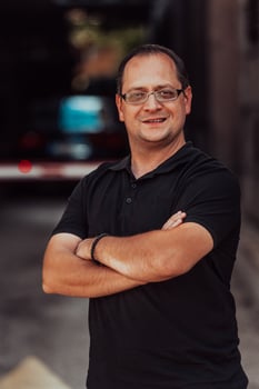 A successful businessman with crossed arms, posing outdoors photo