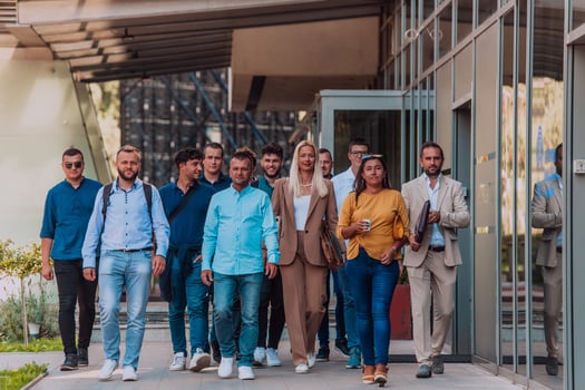 A diverse group of businessmen and colleagues walking together by their workplace, showcasing collaboration and teamwork in the company. photo
