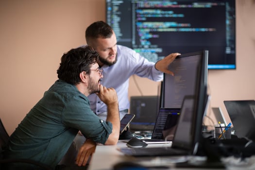 Programmers engrossed in deep collaboration, diligently working together to solve complex problems photo