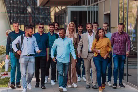 A diverse group of businessmen and colleagues walking together by their workplace, showcasing collaboration and teamwork in the company. photo