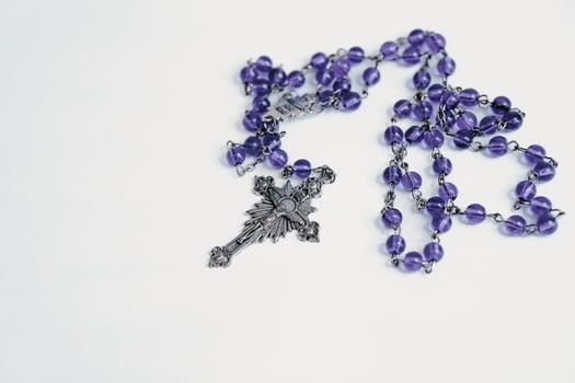 Rosary on plain white background photo