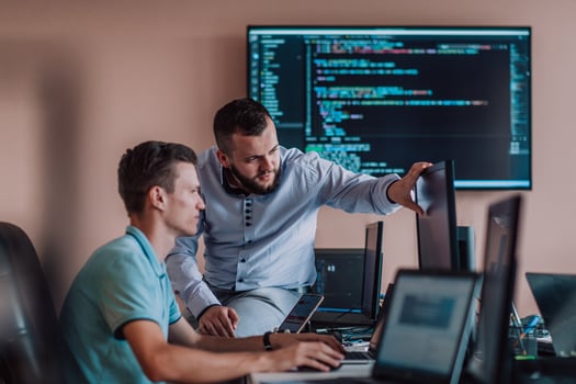 Programmers engrossed in deep collaboration, diligently working together to solve complex problems and develop innovative mobile applications with seamless functionality. photo