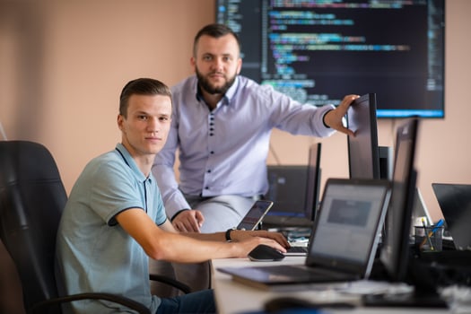 Programmers engrossed in deep collaboration, diligently working together to solve complex problems photo