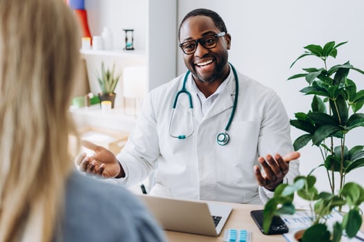 African American doctor consulting for female patient in cabinet photo