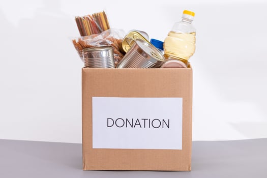 Donation Box of Free Food. Carton Box with Canned Food, Cereals and Grocery. Meal Reserves. Emergency Food Storage in Case of Crisis. Free Social Help, Blessings and Care. Strategic Food Supplies photo