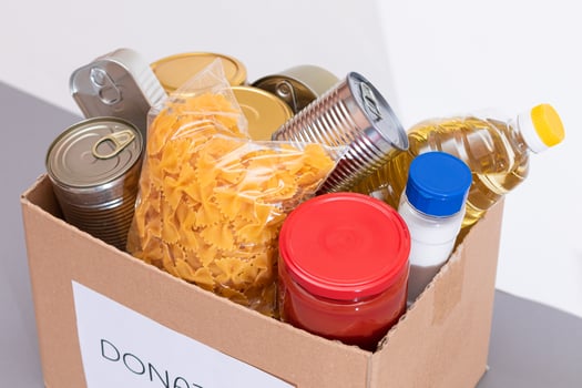 Donation Box of Free Food. Carton Box with Canned Food, Cereals and Grocery. Meal Reserves. Emergency Food Storage in Case of Crisis. Free Social Help, Blessings and Care. Strategic Food Supplies photo