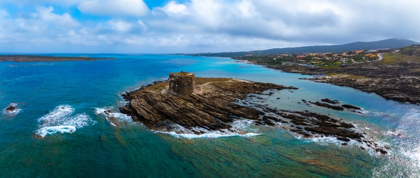 Aerial View of Sardinia's Rugged Coastline with Historical Tower photo