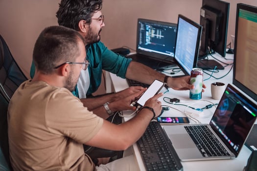 Programmers engrossed in deep collaboration, diligently working together to solve complex problems and develop innovative mobile applications with seamless functionality. photo