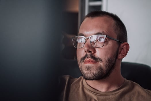 A programmer diligently testing smartphone applications while sitting in their office. photo