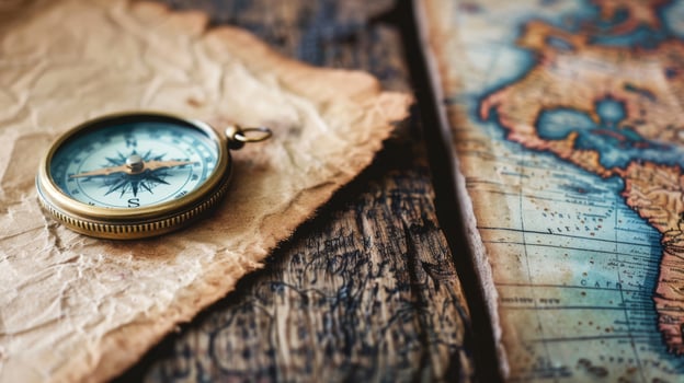 An antique compass rests on a vintage map, atop a rustic wooden table, evoking a sense of adventure and exploration photo